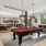 a clubroom with a pool table and chairs