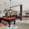 a clubroom with a pool table and chairs