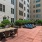 a courtyard with couches, a table and chairs
