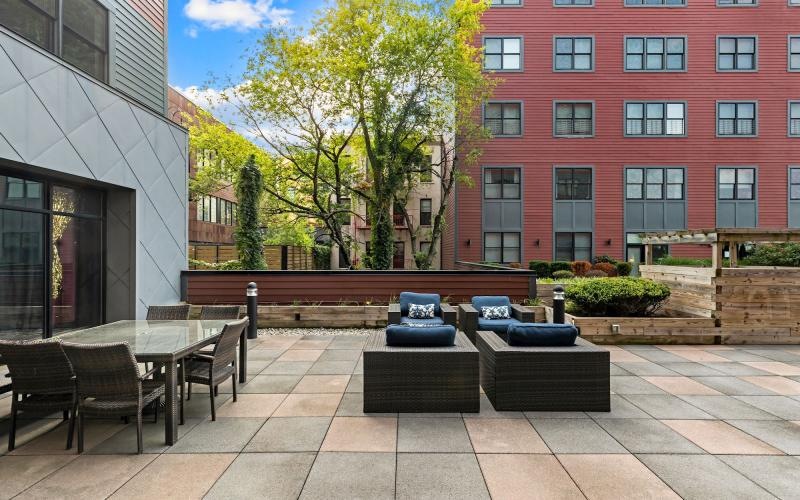 a courtyard with tables and chairs