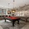 a clubroom with a pool table and chairs