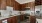 a kitchen with wooden cabinets