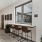 a clubroom with a table chairs and a window