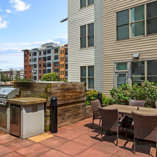 State-of-the-art amenities a grill area a table and chairs