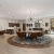 a clubroom with a large round table, chairs and a tv