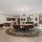 a clubroom with a large round table, chairs and a tv